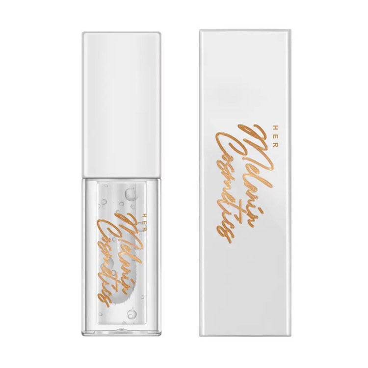 Clear lip oil with sleek white packaging and gold branding, offering a moisturizing, non-sticky formula for a glossy finish.